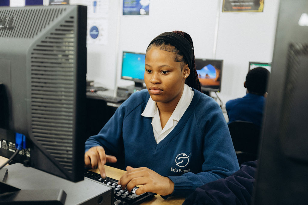 Learner concentrating at a computer workstation