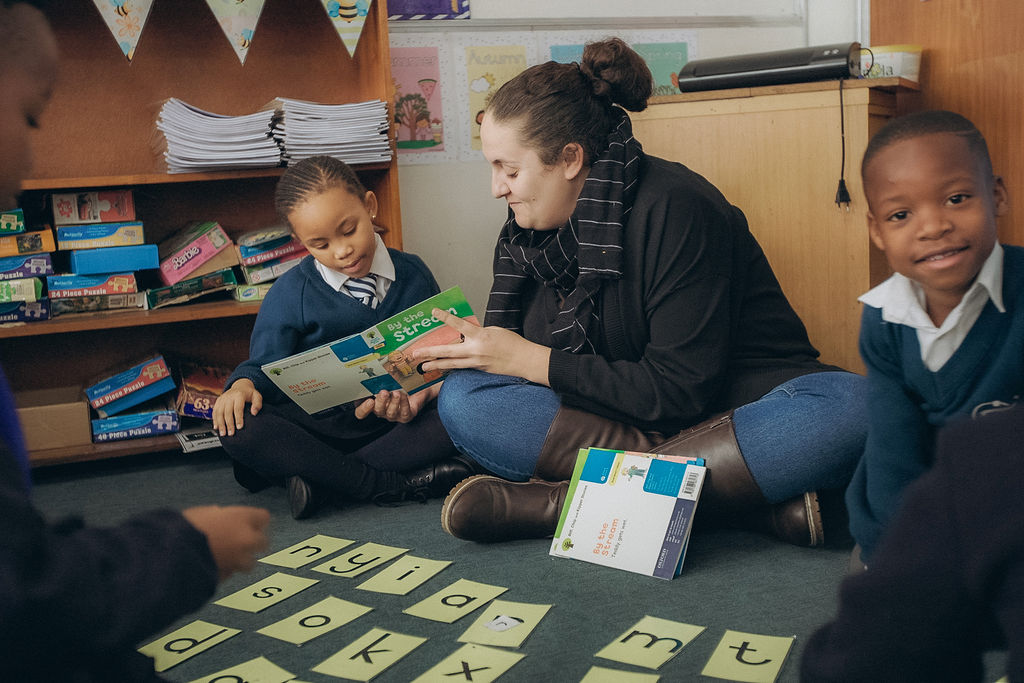 Teacher reading with young learner